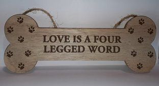 'Love is' bone shaped sign